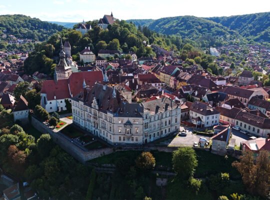 Aerial view of Sighișoara Citadel atop forested hill