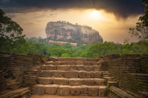 Sigiriya rock fortress seen from ancient stone stairway at sunrise