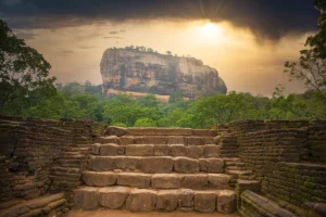 Sigiriya rock fortress seen from ancient stone stairway at sunrise