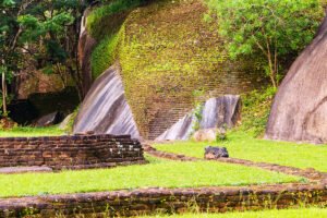 Moss-covered brick walls and rocks at Sigiriya archaeological site