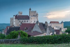 Château de Beynac above Dordogne village at twilight