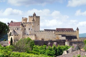 Château de Beynac perched above green Dordogne valley with medieval towers